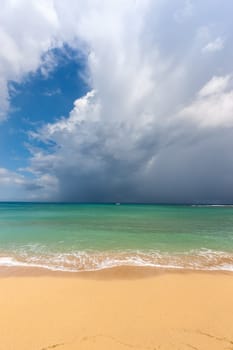 Beach on the tropical island. Clear blue water, sand and clouds. Beautiful vacation spot.
