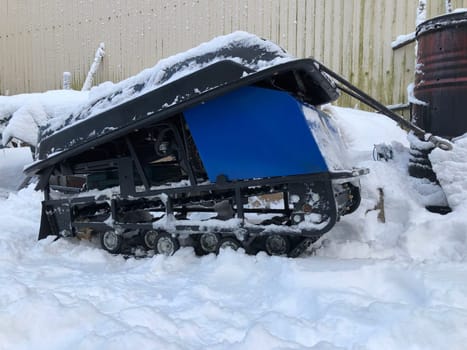 fishing snowmobile tug with sled in the snow