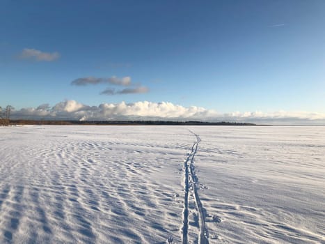 ski track going to the horizon, snowy winter landscape