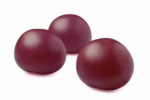 Three purple tomatoes isolated on white background
