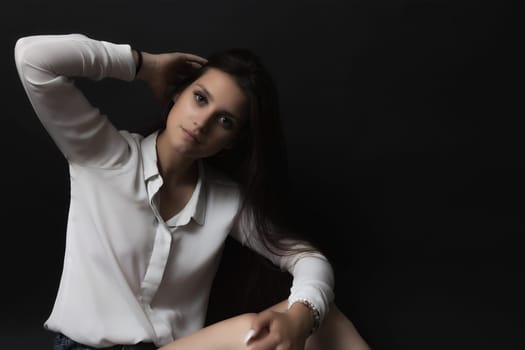 Low key portrait of beautiful long haired brunette girl. Horizontally.