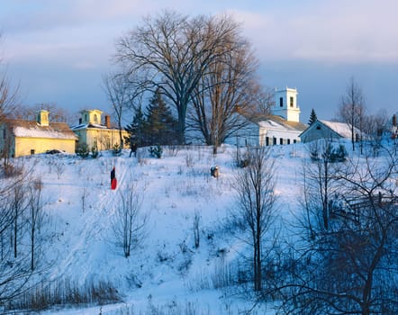 Two boys are sliding in Jericho, Vermont behind the methodist chlurch