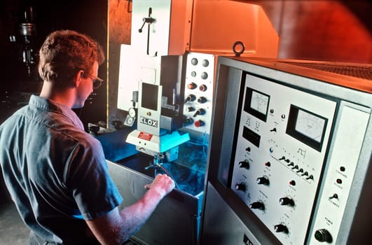 A man working a Cad/Cam machine.