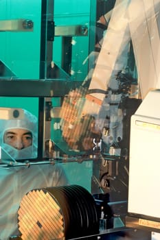 Cleanroom worker in a semi-conductor plant.