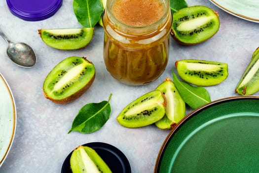 Delicious kiwi jam in a glass jar. Top view. Space for text