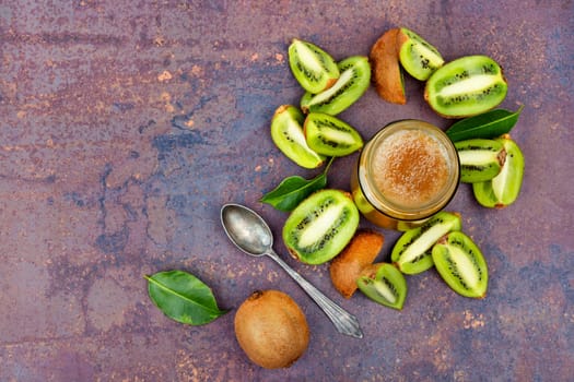 Delicious kiwi jam in a glass jar. Top view. Space for text