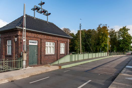 LEER, GERMANY - OCTOBER 02, YEAR: View of the deserted historic Dr.-vom-Bruch bridge with bridge house and barrier in Leer East Friesland.