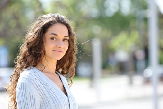 Woman posing looking at camera in the street