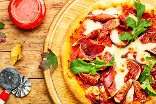 Homemade tasty meat pizza with figs. Flat lay