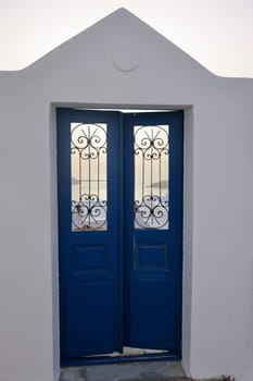 Closed blue door, a traditional piece of architecture on the island of Santorini. Greece