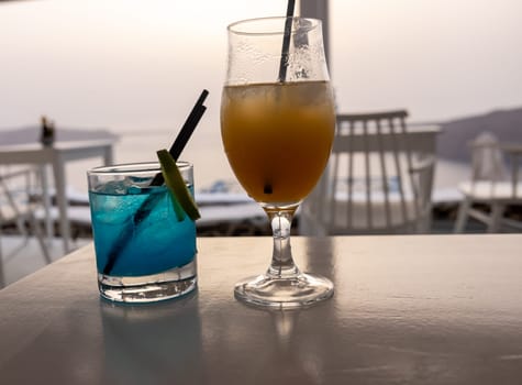 Two cocktails waiting to be drunk during sunset in Santorini