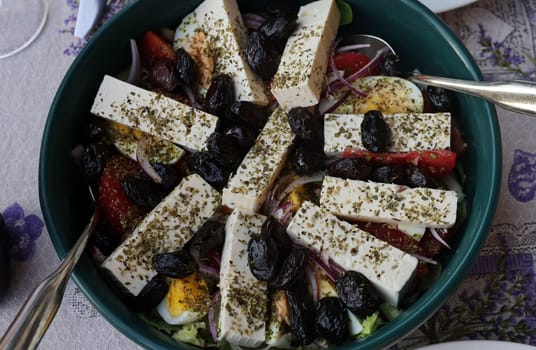 Greek salad with feta cheese and black olives. Typical delicious greek style lunch