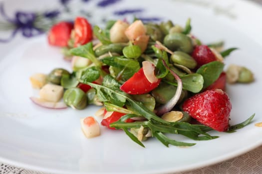 salad with strawberries and broad beans. Delicious dish in a healthy style