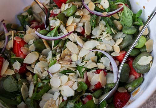 salad with strawberries and broad beans. Delicious dish in a healthy style