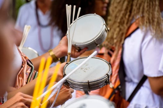 Tambourine player in crowded brazilian streets during traditional carnival festivities