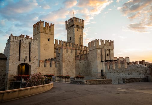 Sirmione, Italy - June 2022: Sirmione castle on Garda lake. Scenic mediaeval building on the water