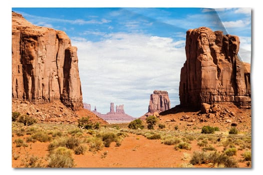 Creative picture of Monument Valley in USA - scenic red landscape with blue sky