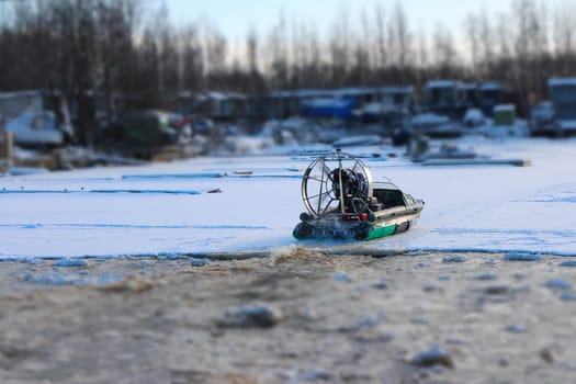 airboat in motion on ice in winter back view