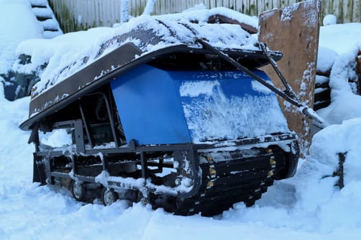 snowmobile tug with sled in the snow winter