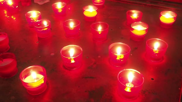 Memorial Day with candle. Commemorative candles are lit. Candle flames burn in the cemetery. Burning candles in the catholic church in Dubrovnik Croatia. Lots of candles. The flame sways in the draft