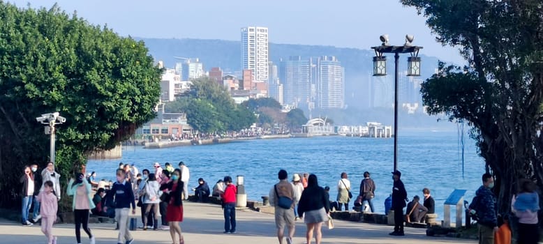 Tamsui, Taiwan - Feb 12, 2023 : people at the Tamsui River, Tamsui street in tamsui district, New taipei city, Taiwan during the sunset.