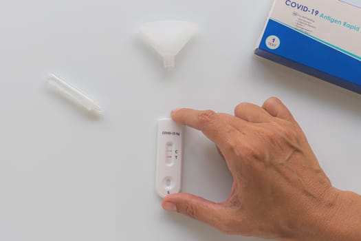 Coronavirus Covid-19 antigen test with positive result on white background.
