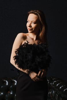 Low key portrait of positive charming woman over black background