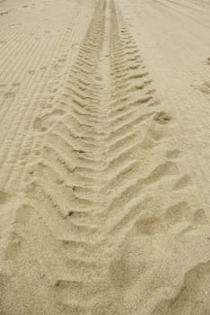 Vehicle wheel sign detail in the sand on the beach
