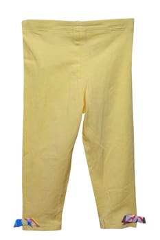 Kids pants isolated. Close-up of a stylish fashionable yellow corduroy trousers with ribbon bows for the little girl. Clipping path. Childrens sporty trousers.