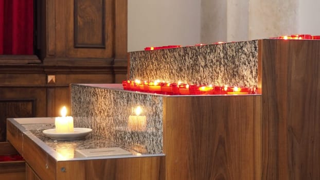 Memorial Day with candle. Commemorative candles are lit. Candle flames burn in the cemetery. Burning candles in the catholic church in Dubrovnik Croatia. Lots of candles. The flame sways in the draft