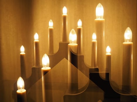 Lamp in the form of candles. Scandinavian symbol welcome. Festive Christmas or New Year's cozy lighting of a house or apartment. Creating a festive atmosphere.
