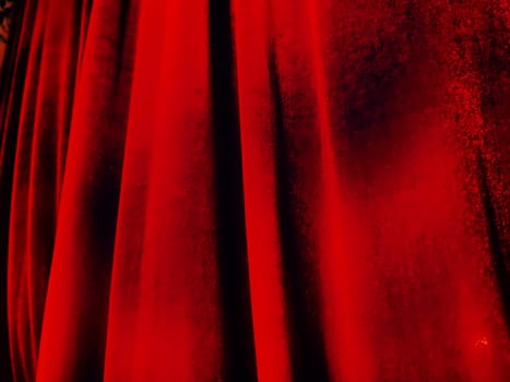 Bright red abstract background reminiscent of pleats of pleasant velvet. Stylized blurred image. Background for New Year, Christmas and Valentine's Day.