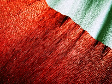 Corrugated paper in red. Uneven surface. Abstract background. Wavy edges of the paper sheet. Lighting gradient.
