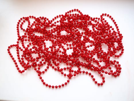 Red beads. Decorative decoration. Women's jewelry. Beautiful shiny bright scarlet beads. Fashion background