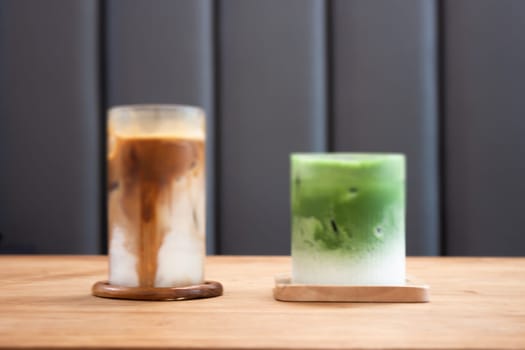 Iced coffee latte and iced matcha greentea on wooden table, stock photo