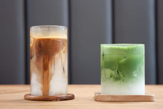 Iced coffee latte and iced matcha greentea on wooden table, stock photo