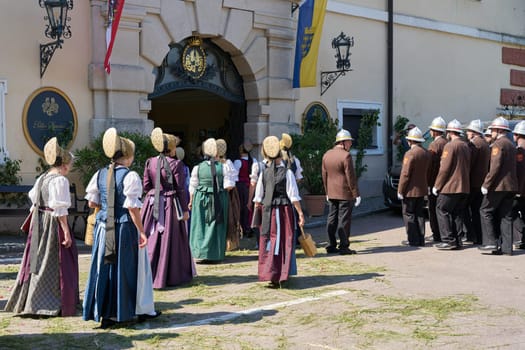 The traditional costume group Duernstein during a procession on Corpus Christi in front of the castle of Duernstein