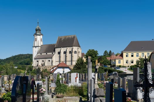 View of the parish church of St. Nicholas above Emmersdorf in Austria seen from the cemetery