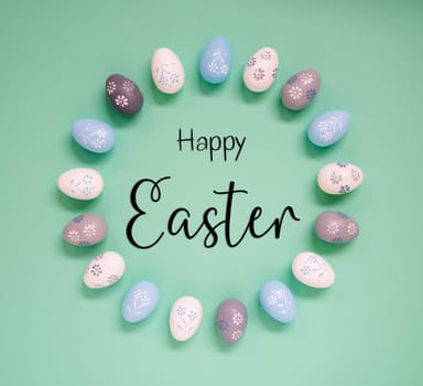 Flat Lay With English Text Happy Easter. Easter Egg Arrangement, Decoration And Ornament. Light Green Paper Background
