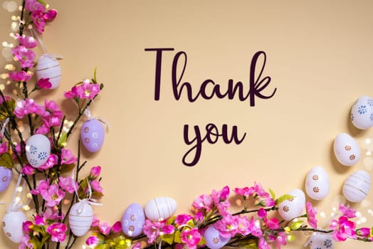 English Text Thank You On Beige Background. Pink And Purple, Shiny And Bright Spring Flower Arrangement With Easter Egg Decoration.