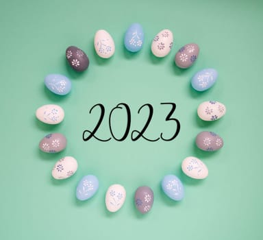 Flat Lay With Text 2023. Easter Egg Arrangement, Decoration And Ornament. Light Green Paper Background