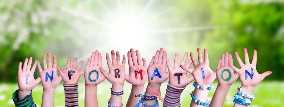 Children Hands Building Colorful English Word Information. Sunny Green Grass Meadow As Background.
