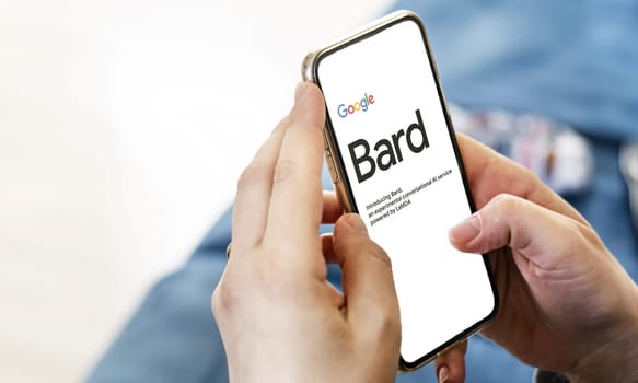 San Francisco US, Jan 2023: Female hands holding a phone with the Google Bard website on the screen. Interior shot. Bard is Google artificial intelligence chatbot