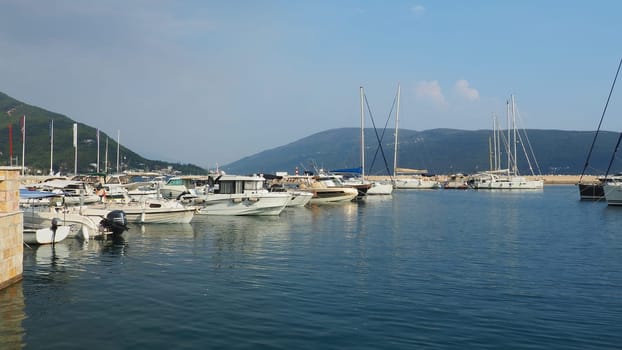 Meljine, Herceg Novi, Montenegro, August 13 2022 Boats, yachts and ships are at anchor. Moored ships in the parking lot. Adriatic Sea Mediterranean. Travel business. Sea travel and sports. Summertime
