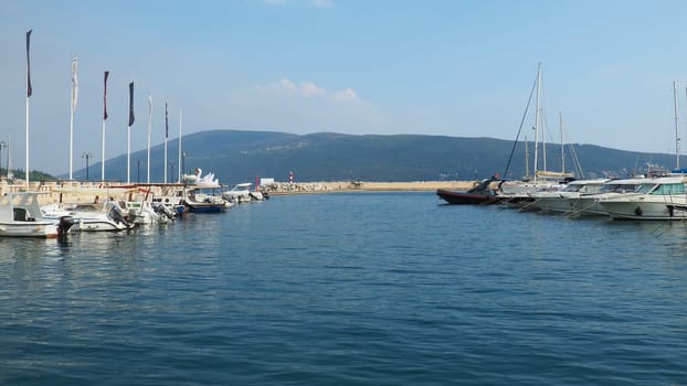 Meljine, Herceg Novi, Montenegro, August 13 2022 Boats, yachts and ships are at anchor. Moored ships in the parking lot. Adriatic Sea Mediterranean. Travel business. Sea travel and sports. Summertime