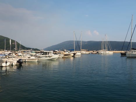 Meljine, Herceg Novi, Montenegro, August 13 2022 Boats, yachts and ships are at anchor. Moored ships in the parking lot. Adriatic Sea Mediterranean. Travel business. Sea travel and sports. Summertime