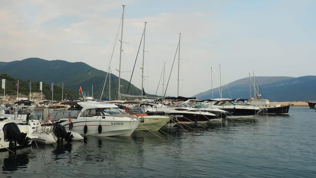 Meljine, Herceg Novi, Montenegro, August 13 2022 Boats, yachts and ships are at anchor. Moored ships in the parking lot. Adriatic Sea Mediterranean. Travel business. Sea travel and sports. Summertime