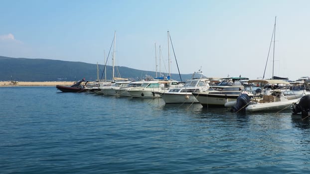 Meljine, Herceg Novi, Montenegro, August 13 2022 Boats, yachts and ships are at anchor. Moored ships in the parking lot. Adriatic Sea Mediterranean. Travel business. Sea travel and sports. Summertime