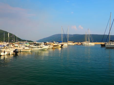 Meljine, Herceg Novi, Montenegro, August 13 2022 Boats, yachts and ships are at anchor. Moored ships in the parking lot. Adriatic Sea Mediterranean. Travel business. Sea travel and sports. Summertime