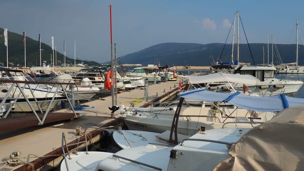 Meljine, Herceg Novi, Montenegro, August 13 2022 Boats, yachts and ships are at anchor. Moored ships in the parking lot. Adriatic Sea Mediterranean. Travel business. Sea travel and sports. Summertime